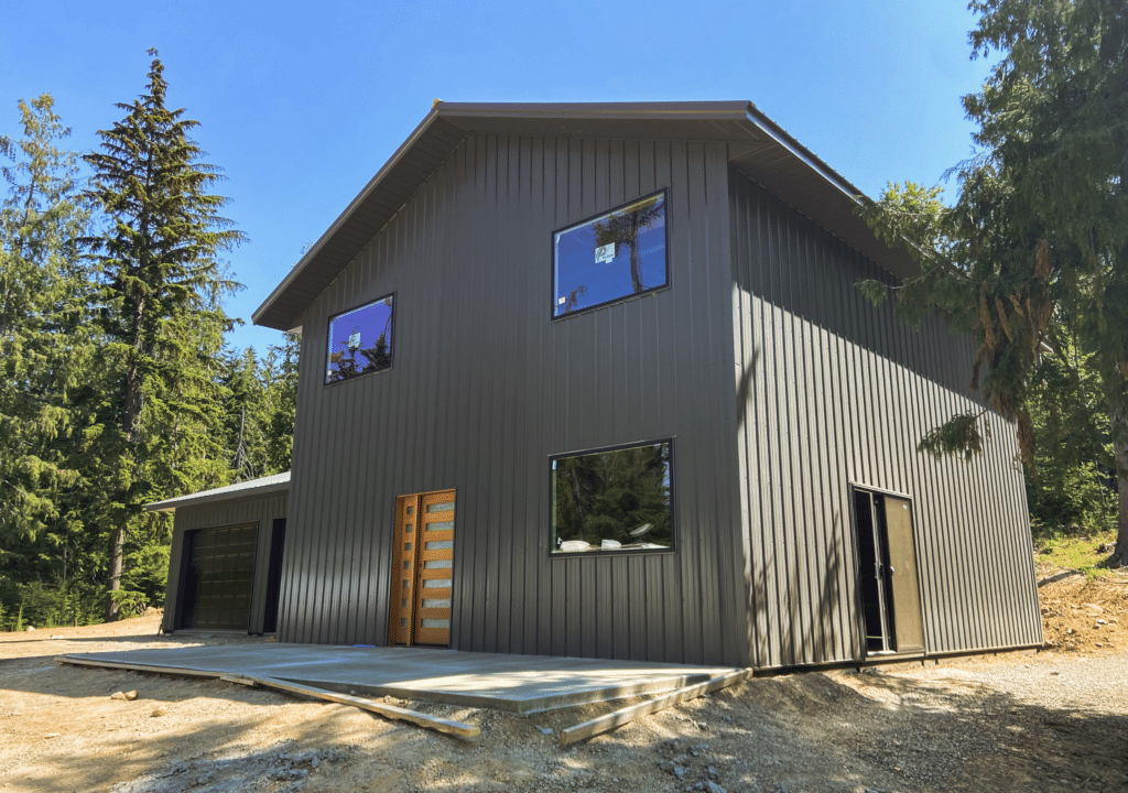 A 24x32x10 Garage attaching to 28x32x18 Barndominium shell, Built by MQS, featuring Dark Grey Metal Siding and Roofing available for custom order in MT, ID, WA, & WY A 24x32x10 Garage attaching to 28x32x18 Barndominium shell, built by MQS, featuring Dark Grey Metal Siding and Roofing available for custom order in MT, ID, WA, & WY