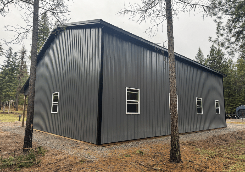 30x48x16 Hobby_Workshop_Home Garage, built by MQS, featuring dark grey metal siding, with black metal trim and roofing, in Thompson Falls, MT 30x48x16 Hobby Workshop Home Garage, built by MQS, featuring dark grey metal siding, with black metal trim and roofing, in Thompson Falls, MT