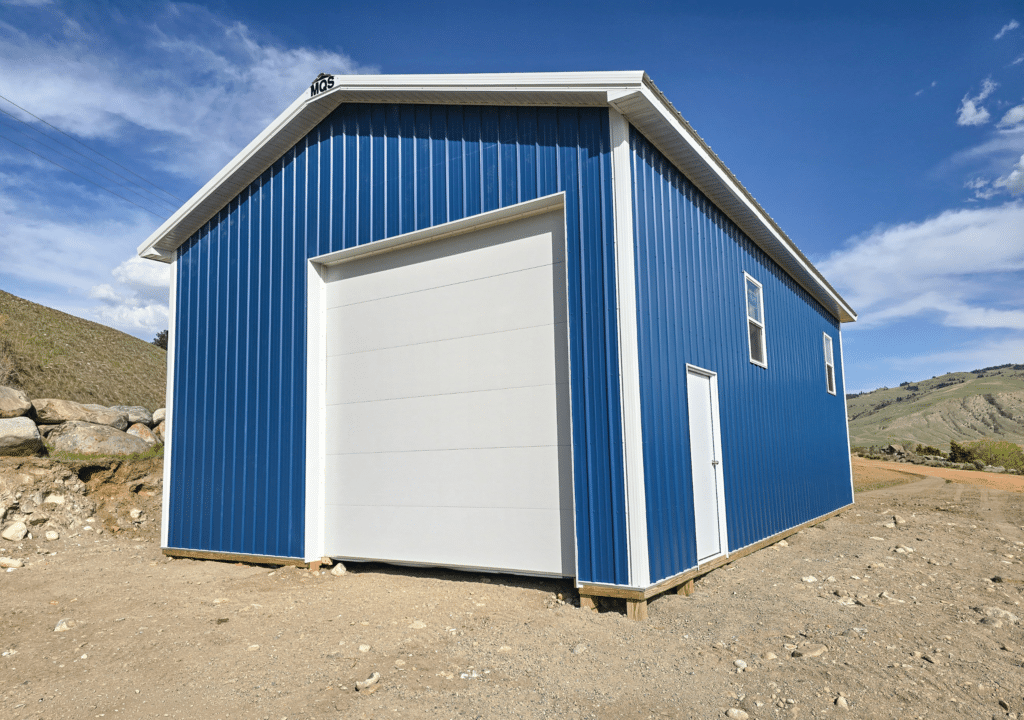 A 24x40x14 Commercial Vehicle_RV Storage, Built By MQS, Featuring Blue Metal Siding, White Metal Trim, And White Metal Roofing, In Gardiner, Montana A 24x40x14 Commercial Vehicle_RV Storage, Built By MQS, Featuring Blue Metal Siding, White Metal Trim, And White Metal Roofing, In Gardiner, Montana