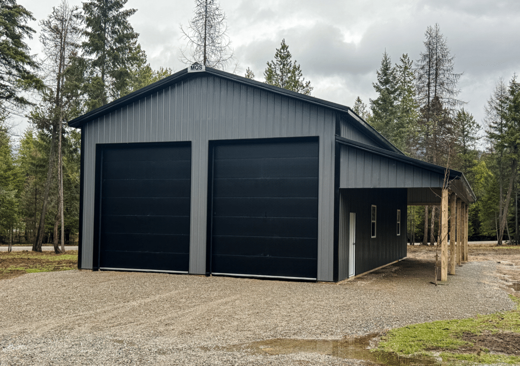 A 30x48x16 Hobby_Workshop_Home Garage, built by MQS, featuring dark grey metal siding and black metal roofing, in Thompson Falls, MT A 30x48x16 Hobby Workshop Home Garage, built by MQS, featuring dark grey metal siding and black metal roofing, in Thompson Falls, MT