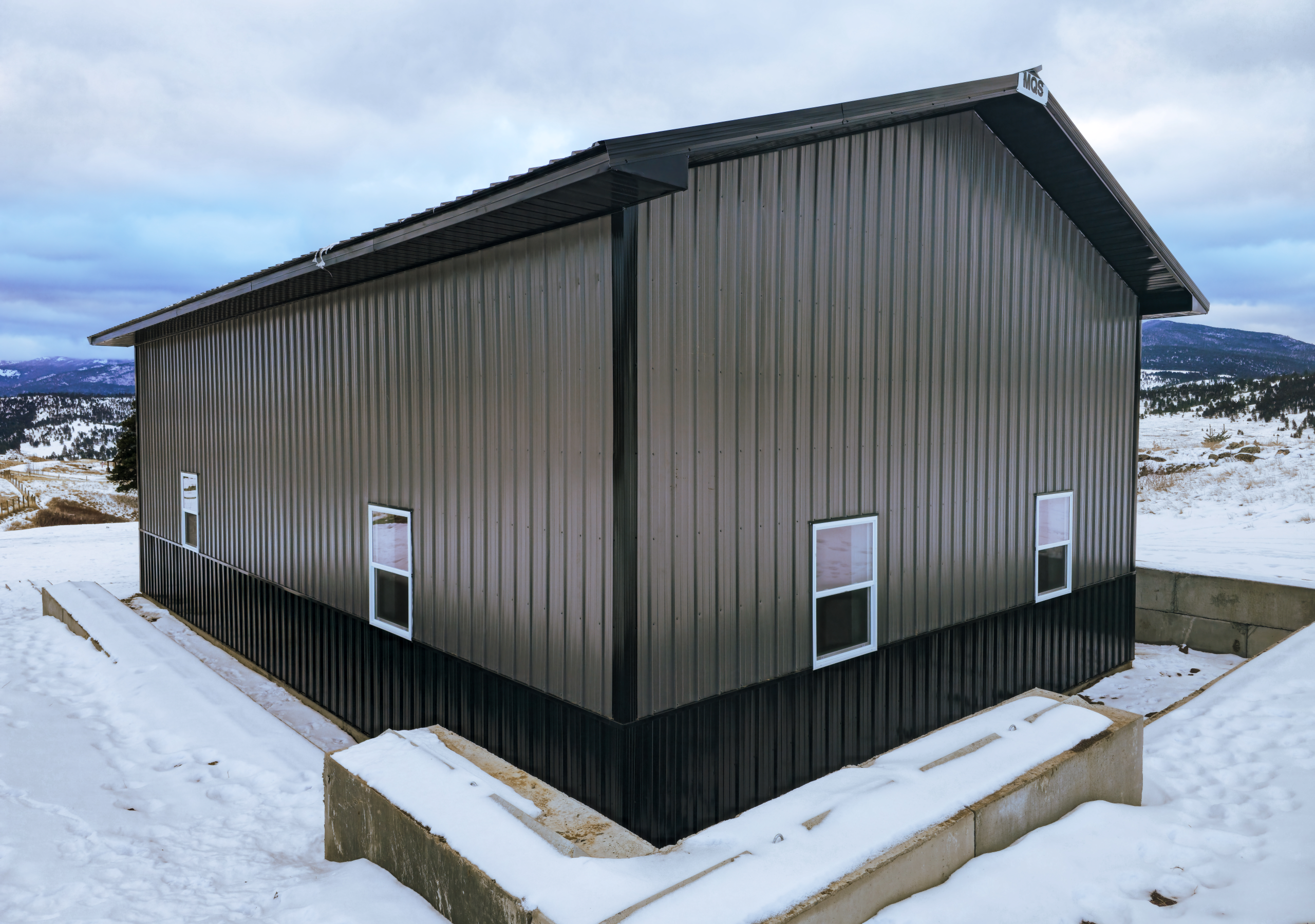 A 30x48x16 Single door Vehicle_RV Storage, built by MQS, Gray metal siding, Black metal Trim and Roofing. In Jefferson City, Montana
