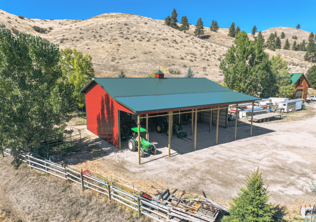A 36x60x18 Hay_AG Equipment Storage, Built by MQS, with 14x60 open sided lean-to, with red metal siding and Green metal trim and roofing, in Darby, MT A 36x60x18 Hay_AG Equipment Storage, Built by MQS, with 14x60 open sided lean-to, with red metal siding and Green metal trim and roofing, in Darby, MT