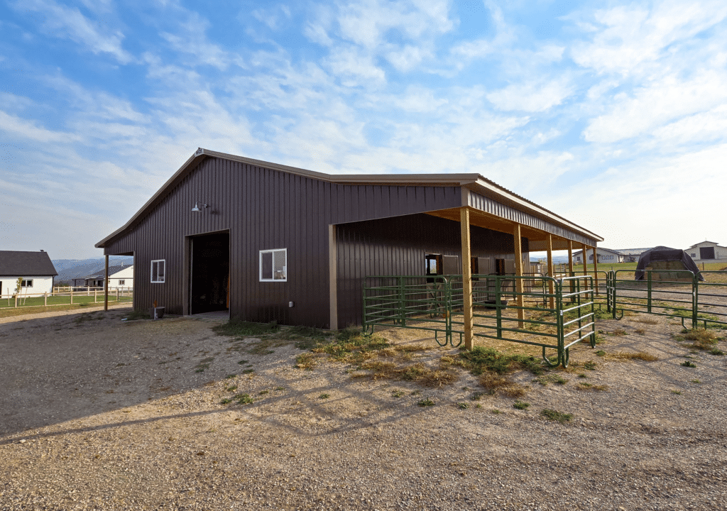 A 40x60x12 Horse Barn_Stable, built by MQS, featuring dark brown metal siding and roofing, and Tan Metal Trim, in Helena, Montana A 40x60x12 Horse Barn_Stable, built by MQS, featuring dark brown metal siding and roofing, and Tan Metal Trim, in Helena, Montana