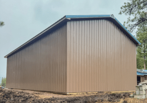 A 26x48x14 RV Storage Pole Barn, Featuring Desert Brown metal siding, and Hawaiian Blue metal roofing, Built By MQS, in Bonner, MT