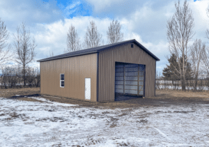 A 30x40x14 Hobby Workshop Garage Residential Pole Barn, Featuring Brown Metal siding, and Dark Brown Metal Trim and Roofing, Built By MQS in Columbia Falls, MT