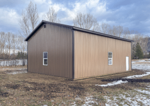 A 30x40x14 Hobby Workshop Garage Residential Pole Barn, Featuring Brown Metal siding, and Dark Brown Metal Trim and Roofing, Built By MQS in Columbia Falls, Montana
