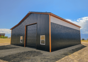 A 30x48x16 Vehicle_RV storage residential pole barn, Built By MQS, featuring Dark Grey metal Siding, Copper Penny Metal Trim, and black metal roofing, in Florence, MT