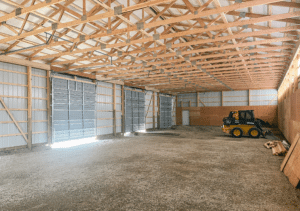 A 40x100x14 Hay and Ag Equipment Storage Interior, featuring rural red metal siding, and medium green metal roofing, Interior, Built By MQS in Kalispell, MT