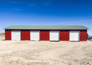A 40x100x14 Hay and Ag Equipment Storage, featuring rural red metal siding, and medium green metal roofing, Built By MQS in Kalispell, MT