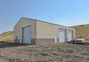 A 40x64x16 Commercial General Manufacturing Warehouse Pole Barn With Ivory Metal Siding and Taupe metal Roofing and Wainscoting available for custom order by MQS in Montana