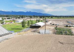 A 44x90x12 Commercial Ag Horse Shelter Pole Building, featuring white metal siding, with rural red metal trim, Built By MQS, in Hamilton, MT.jpg
