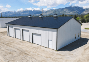 A medium commercial multipurpose garage, featuring White metal siding, and black metal trim and roofing available for custom order by MQS in Gallatin County, Montana