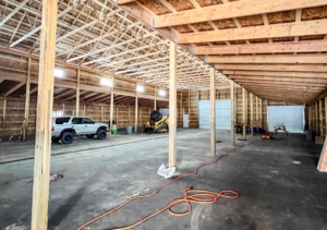 The interior of a 40x100x20 Multi-Stall Monitor Style Horse_Equine Equestrian pole Barn, Built By MQS, featuring Distressed Gray Barnwood Metal Siding, and Burnished slate Roofing, in Elliston, MT