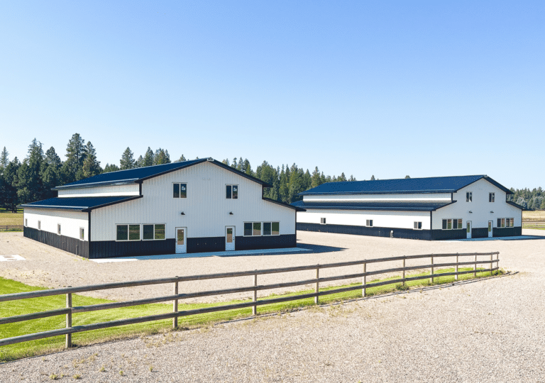 two 36x88x18 Mixed-use Commercial pole barns with both offices and storage spaces, Featuring White Metal Siding, With Black Metal Roofing, available for custom build by MQS in Flathead County, MT