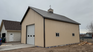 A 26x36x14 Residential hobby shop, built by MQS, featuring Ivory Metal Siding, and Burnished Slate Metal Trim and Roofing, In Helena, MT