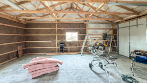 A 30x40x10 Hobby_workshop_home garage Interior, built by MQS, featuring Medium green metal siding, and weathered copper metal roofing, in Helena, MT