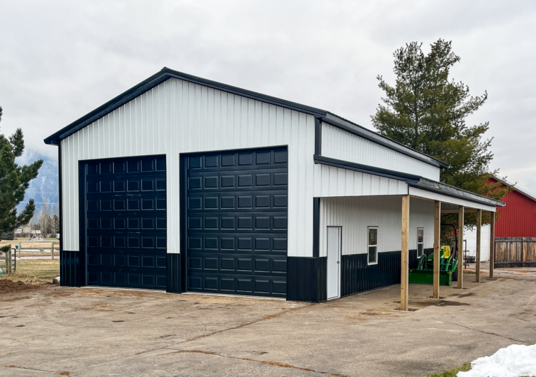 A 32x44x16 Hobby_Workshop Garage Residential Pole Barn, Featuring white metal siding, and black metal trim and roofing, available for custom build by MQS in Missoula County