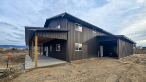40x64x16 Bardominium shell with a Garage, with Lean-Tos, Built By MQS, Featuring Gray Metal Siding, And Black Metal Roofing, in Stevensville, MT