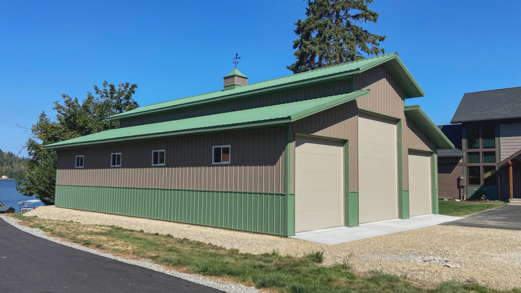 A 14x56x18 Vehicle Storage Garage pole barn with 2 enclosed lean-tos, with Taupe Metal Siding, and Green Metal Wainscoting and Roofing, available for custom build with all needed permit documents in MT