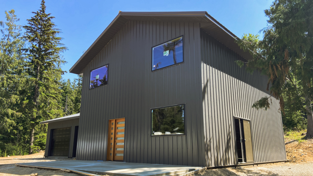 A 24x32x10 Garage attaching to 28x32x18 Barndominium shell, featuring Dark Grey Metal Siding and Roofing available for custom build by MQS, with permit assistance in MT